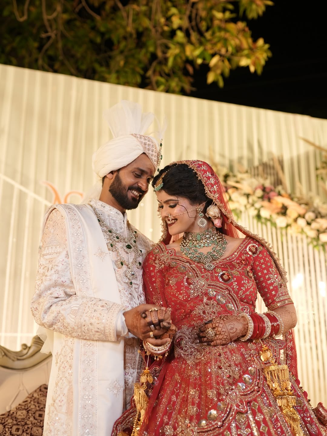 Bride in a royal red bridal lehenga and gold jewellery, Anjali Films Gurugram the Best Wedding Photographer in Gurgaon 