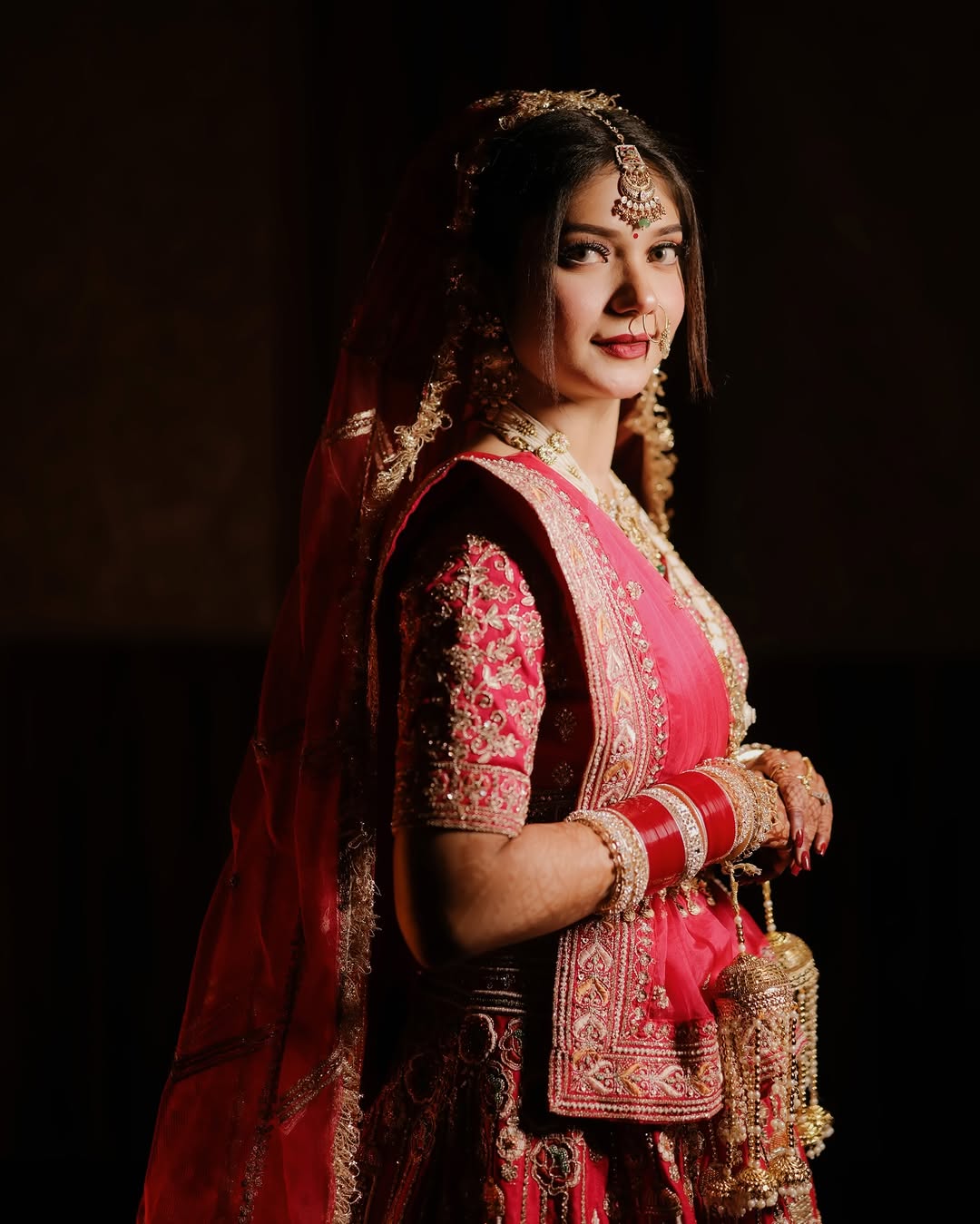 Bride glowing in traditional wedding attire, candid portrait by Anjali Films